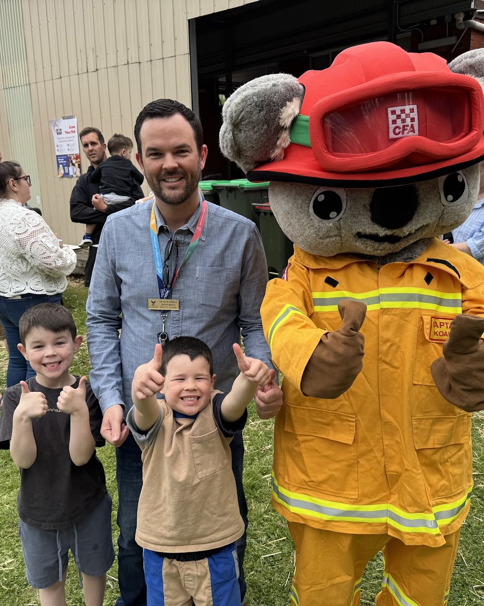 Glen Atwell and his two sons giving a thumbs up beside the CFA koala mascot